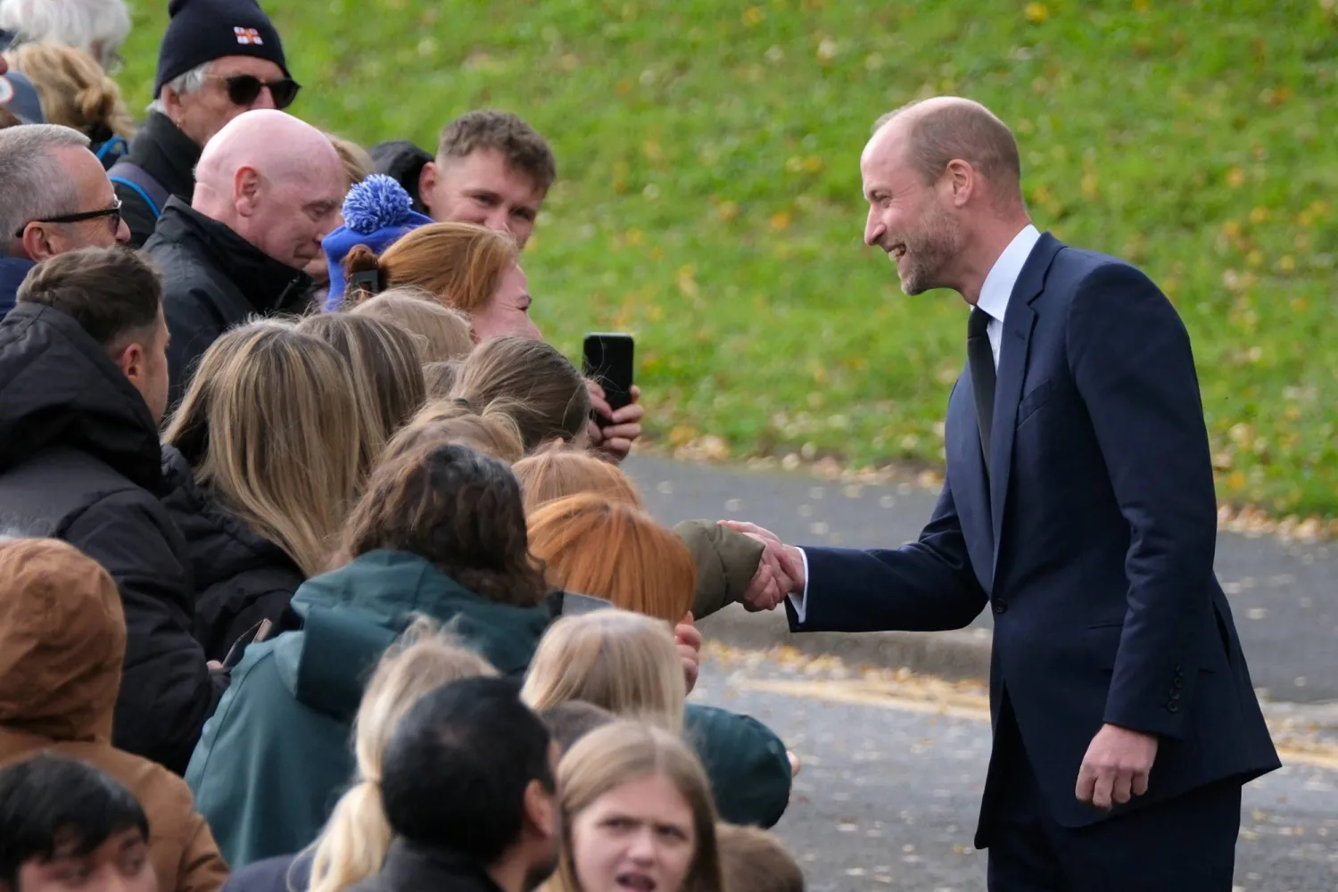 Britain's Prince William meets with the public on a street during a royal visit to the Aberfan Disaster Memorial Garden to mark the 60th anniversary of the 1966 disaster, in which 109 children and five teachers were killed at Pantglas Junior School when a coal spoil tip collapsed onto the Welsh village, Britain, October 21, 2026. (Reuters)