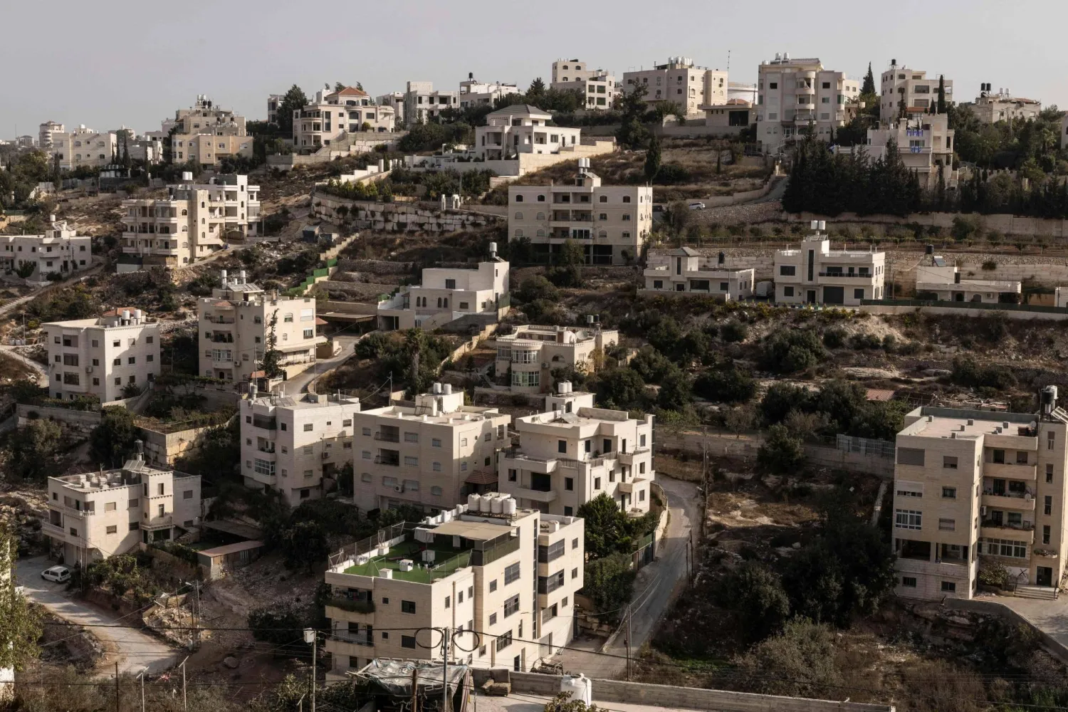 This picture shows empty residential buildings after the Israeli army forced Palestinians to evacuate the Ein Deir Baha neighborhood in occupied West Bank city of Hebron on October 24, 2026. (Photo by JOHN WESSELS / AFP)