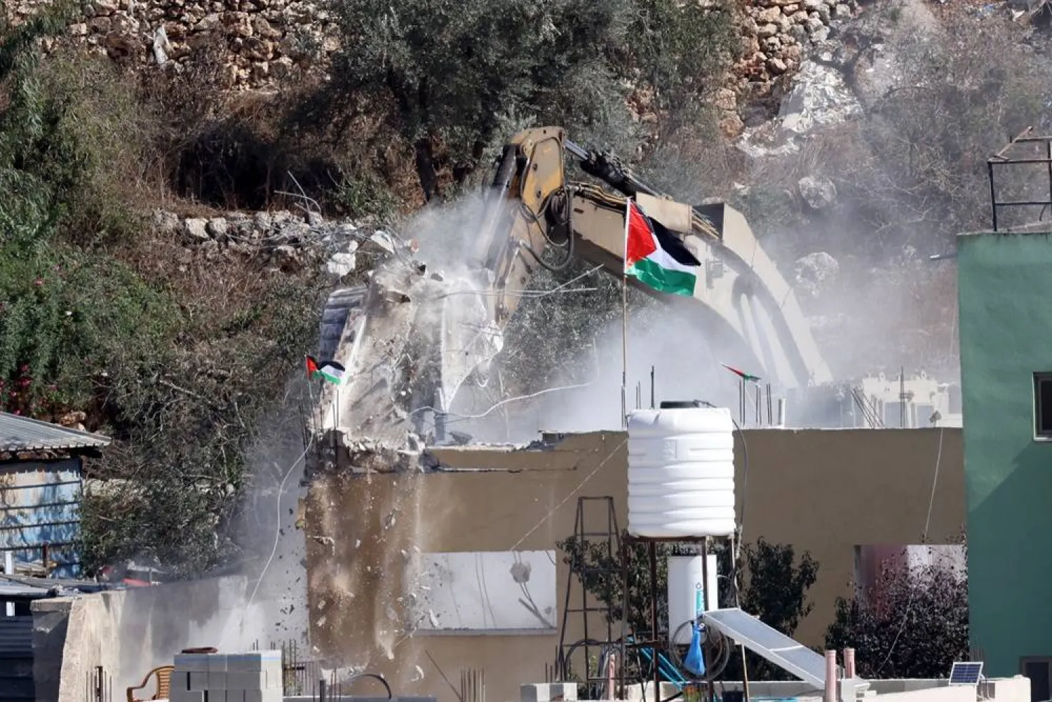 n Israeli bulldozer demolishes the house of Palestinian prisoner Ibrahim Abdul Karim Daoud at the West Bank village of Beita, 28 October 2026. (EPA)