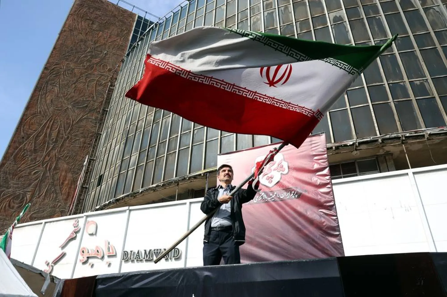 A man holds Iran's national flag in a street of Tehran, Iran, 31 October 2026. (EPA)