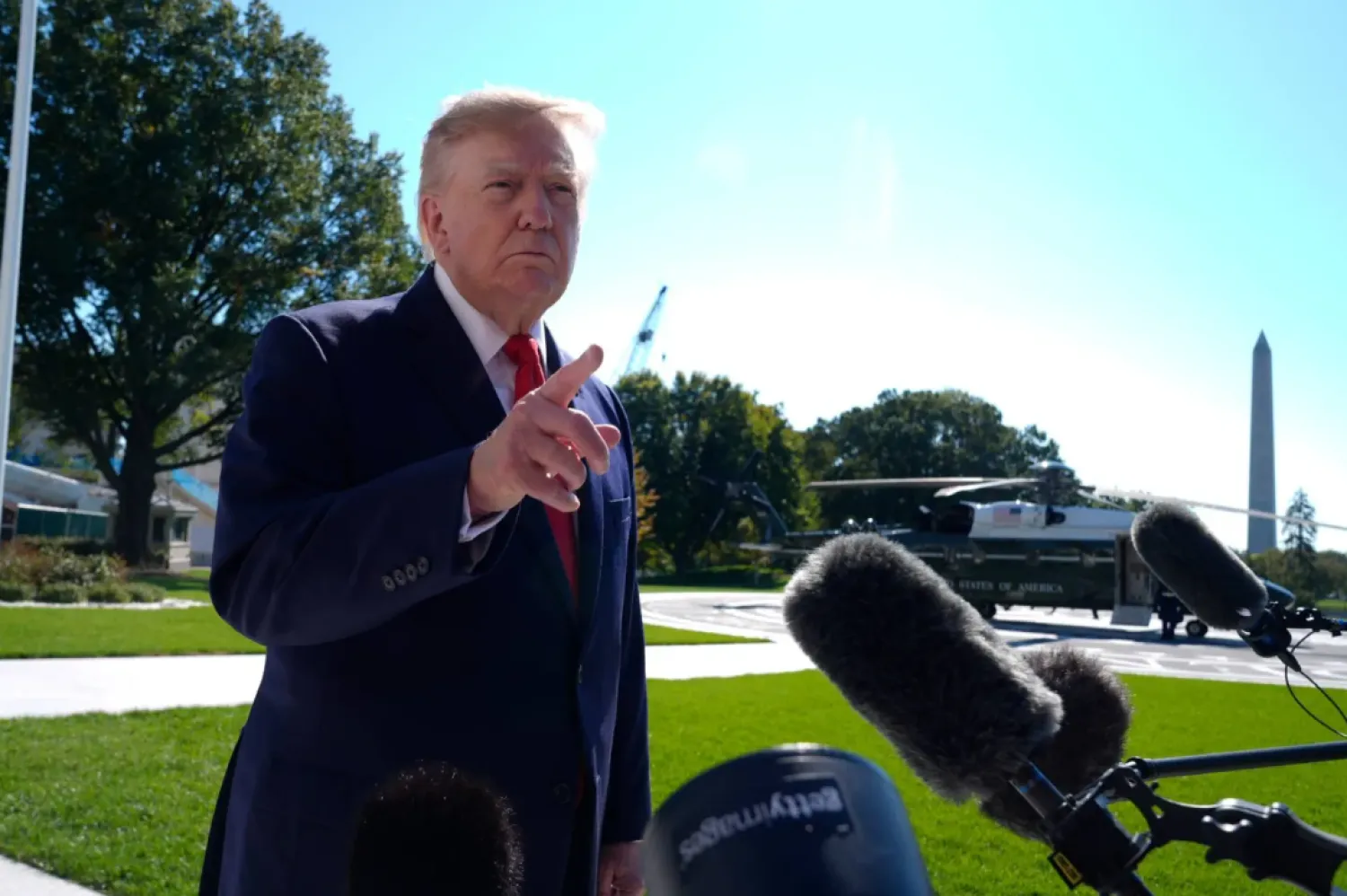 President Donald Trump talks to reporters before boarding Marine One on the South Lawn of the White House, Tuesday, Oct. 13, 2026, in Washington. (AP Photo/Manuel Balce Ceneta)