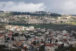 A picture taken in the village of Turmus Ayya near Ramallah city shows the nearby Israeli Shilo settlement in the background, in the occupied West Bank on February 18, 2024. (Photo by Jaafar ASHTIYEH / AFP)

