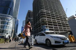 A woman walks in a street in the Central Business District (CBD) area in Beijing, China, 04 December 2024. EPA/WU HAO