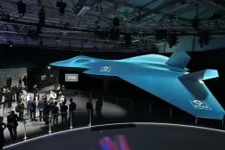 Delegates look at the Global Combat Air Program (GCAP) 6th generation fighter jet concept design at the Farnborough International Airshow 2024 - AFP

