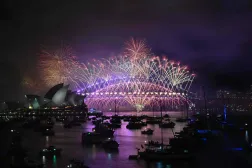Fireworks light up the midnight sky over Sydney Harbour Bridge and Sydney Opera House during 2025 New Year Day celebrations in Sydney on January 1, 2025. (Photo by Saeed KHAN / AFP)