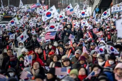 Participants wave US and South Korean flags during a rally to support impeached South Korea's President Yoon Suk Yeol near the presidential residence in Seoul on January 1, 2025. (AFP) 