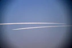 Condensation trails from the airplanes are seen in the sky in Islamabad on January 1, 2025. (AFP) 