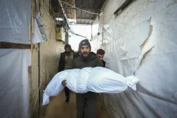  The body of a victim of an Israeli army strike on a house in the Bureij refugee camp is carried for the funeral at the Al-Aqsa Martyrs Hospital in the central Gaza Strip town of Deir al-Balah Wednesday, Jan. 1, 2025. (AP)