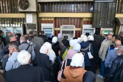 Syrian civil servants must queue at one of two state banks or affiliated ATMs, and withdrawals are capped. LOUAI BESHARA / AFP
