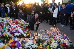Liberal Leader Mark Carney takes a moment after lighting a candle at a memorial for victims after a vehicle drove into a crowd during a Filipino heritage festival in Vancouver, British Columbia, Sunday, April 27, 2025. (Sean Kilpatrick/The Canadian Press via AP)