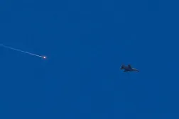 An Israeli fighter aircraft fires a flare as it flies over the predominantly Druze city of Sweida on July 15, 2025, following clashes between Bedouin tribes and Druze fighters. (AFP)