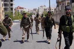 Syrian security forces walk together along a street, after clashes between Syrian government troops and local Druze fighters resumed in the southern Druze city of Sweida early on Wednesday, collapsing a ceasefire announced just hours earlier that aimed to put an end to days of deadly sectarian bloodshed, in Sweida, Syria July 16, 2025. REUTERS/Karam al-Masri