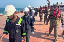  Iraqi navy officers escort crew members onboard the Liberian-flagged oil tanker Liliana, detained in Iraq's territorial waters near Basra's oil terminal, Iraq, August 5, 2025. (Reuters)