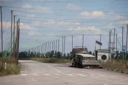 A view shows a burned vehicle and anti-drone nets installed over a road near the frontline town of Dobropillia, amid Russia's attack on Ukraine, in Donetsk region, Ukraine August 10, 2025. (Reuters)