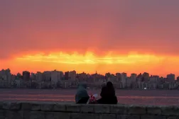 Women sit by the coast of the Mediterranean Sea during sunset, in Alexandria, Egypt October 8, 2023. REUTERS/Mohamed Abd El Ghany 