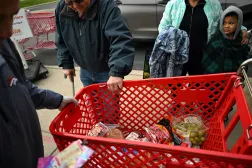 People wait in line outside Adams County Emergency Food Bank for their completed grocery cart, weeks into the continuing US government shutdown, in Commerce City, Colorado, US October 31, 2025.  REUTERS/Mark Makela