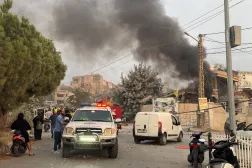 FILE PHOTO: People gather as smoke rises after Israeli strikes following Israeli military's evacuation orders, in Tayr Debba, southern Lebanon November 6, 2025. REUTERS/Ali Hankir/File Photo