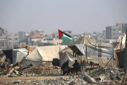 Palestinians sit outside their make shift homes along a road near the Nuseirat refugee camp in the central Gaza Strip, on November 9, 2025, following a US-brokered truce that halted the two-year war. (AFP)