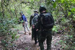 This handout photo taken and released by the Royal Thai Army on November 10, 2025 shows Thai army and police on patrol searching for landmines in Sisasket Province along the Cambodia-Thailand border. (Handout / Royal Thai Army / AFP)