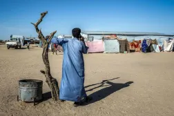A Sudanese refugee speaks on the phone at the Tine transit camp in Chad on November 8, 2025. (AFP)