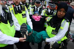 Police officers detain a protester during a mass demonstration organized by Defend our Juries, against the British government's ban on Palestine Action, at Trafalgar Square in London, Britain, October 4, 2025. REUTERS/Toby Melville
