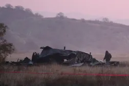 A member of emergency services works at the site of the Turkish C-130 military cargo plane crash near the Azerbaijani border, in Sighnaghi municipality, Georgia, November 12, 2025. REUTERS/Irakli Gedenidze 