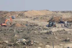 A machinery operates next to a Red Cross vehicle at an area within the so-called "yellow line" to which Israeli troops withdrew under the ceasefire, as Hamas says it continues to search for the bodies of deceased hostages seized during the October 7, 2023, attack on Israel, in Gaza City November 12, 2025. REUTERS/Dawoud Abu Alkas Purchase Licensing Rights