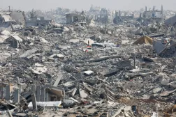 Palestinians stand next to the rubble of destroyed buildings, amid a ceasefire between Israel and Hamas, in Gaza City, November 2, 2025. REUTERS/Mahmoud Issa