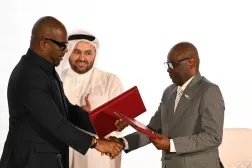 Qatar's chief negotiator Mohammed al-Khulaifi (C) observes as Sumbu Sita Mambu (L), a high representative of the head of state in the Democratic Republic of Congo (DRC) and and Rwanda-backed armed group M23 executive secretary Benjamin Mbonimpa (R) as they shake hands during the signing ceremony of the Comprehensive Peace Agreement between the DRC Government and the Congo River Alliance/March 23 Movement (AFC/M23) at the Sheraton Hotel in Doha, on November 15, 2025. (AFP)
