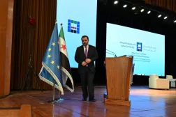 Syrian Minister of Foreign Affairs and Expatriates Asaad al-Shaibani leaves the stage after addressing delegates during a day of dialogue with Syrian civil society, a first step towards structured dialogue with the Syrian government and the European Union, at Conference Palace near Damascus on November 15, 2025. (AFP) 
