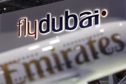 The logos of 'flydubai' and 'Emirates' feature on displays at the Dubai Airshow, in Dubai, United Arab Emirates, November 17, 2025. REUTERS/Amr Alfiky