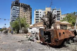 Members of army walks near a destroyed military vehicle and bombed buildings, as Sudan's army retakes ground and some displaced residents return to ravaged capital in the state of Khartoum Sudan March 26, 2025. (Reuters)
