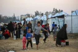 Palestinians fill water containers at the Nuseirat camp for displaced families in central Gaza (AFP)