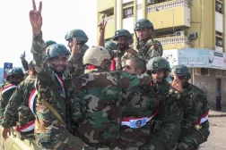 Yemeni armed forces flash the V-sign for victory as they ride in the back of a lorry as they celebrate the 58th anniversary of National Independence Day, in the port city of Aden, November 30, 2025. (Photo by Saleh Al-OBEIDI / AFP)