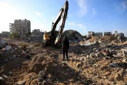 A Palestinian gunman stands guard as Hamas and Islamic Jihad fighters transport a white body bag believed to carry the remains of an Israeli hostage in the town of Beit Lahia in the northern Gaza Strip on December 3, 2025. (AFP)