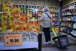 A shopper browses past shelves at a supermarket in Beijing on December 10, 2025. (AFP)