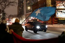 A demonstrator waves a flag of Somalia as a vehicle passes by a rally in protest against Immigration and Customs Enforcement (ICE), amid a reported federal immigration operation targeting the Somali community, in Minneapolis, Minnesota, US December 8, 2025. REUTERS/Tim Evans/File Photo 