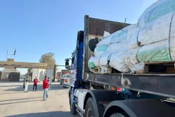 شاحنات محمَّلة بالمساعدات الإنسانية السعودية لدى عبورها منفذ رفح (مركز الملك سلمان للإغاثة)