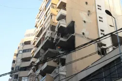 People inspect a damaged building, after Israeli military said on Sunday that it struck a militant from the Lebanese Iran-aligned Hezbollah group, in Beirut's southern suburbs, Lebanon November 23, 2025. REUTERS/Mohamed Azakir 