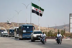 A convoy of buses carry Syrian refugees who return home from Lebanon, arrive at the Syrian border crossing point, in Jdeidet Yabous, Syria, Tuesday, July 29, 2025. (AP)