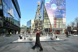  People walk past a Christmas tree at the Taikoo Li shopping center in Beijing on December 24, 2025. (AFP)