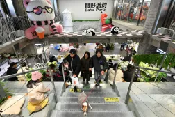 People visit a shopping center in Beijing on December 20, 2025. (AFP)