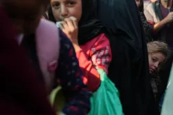 Gazze'nin merkezindeki Deyr el-Belah'ta dün bir yardım kuruluşunun mutfağından yemek almak için bekleyen kuyruklar arasında Filistinli bir kız çocuğu, (AP)