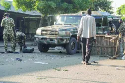 Military personnel inspect the scene of the explosion at a mosque in the Gamboru market in Maiduguri on December 25, 2025. (Photo by Audu MARTE / AFP)