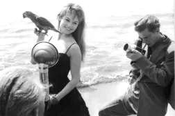 FILED - 01 April 1956, France, Cannes: Then French actress and singer Brigitte Bardot is photographed with a parrot in her hand on the beach during the Cannes Film Festival. Photo: -/AFP Intercontinentale/dpa