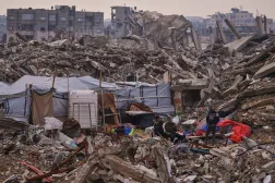  Palestinians stand next to a tent set up on the rubble of buildings destroyed during Israeli air and ground operations in the Sheikh Radwan neighborhood, in Gaza City, Tuesday, Dec. 30, 2025. (AP) 