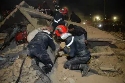 Emergency personnel search for victims in the rubble of two collapsed buildings in Fez late on December 9, 2025. (AFP) 