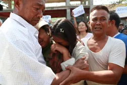سجين مُفرج عنه (يسار) وسط عائلته لدى إطلاق سراحه من «سجن إنسين» في يانغون بميانمار (إ.ب.أ)