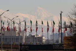  This photo taken on January 4, 2026, shows a view Iranian flags west of Tehran towards the summit of Mount Damavand, Iran's highest peak and a potentially-active strato-volcano, in the northern province of Mazandaran. (AFP) 