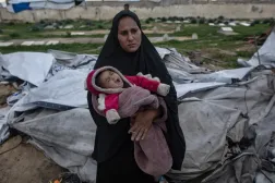 Güçlü rüzgar ve yağmur nedeniyle Gazze Şeridi'nin güneyindeki Han Yunus'ta çadırı yıkılan Filistinli bir kadın bebeğiyle (EPA)